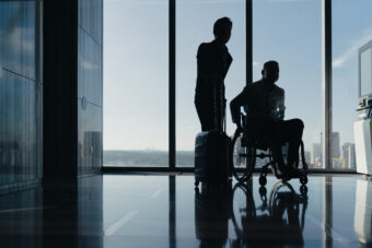 Outward mobility: a young man in a wheelchair is waiting at the airport.